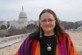 Susan Shown Harjo standing in front of the American Academy of Arts & Sciences