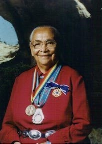 A picture of Annie Dodge Wauneka in a red shirt and medals around her neck